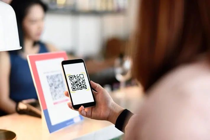 Customer Scanning QR Code at Small Business